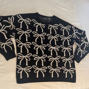 Black and White Sweater with White Bow Design